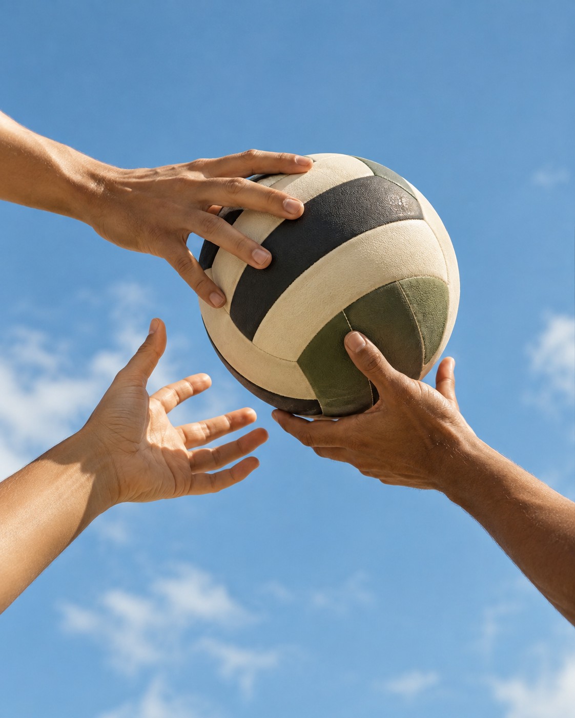 Illustrative scene: Three adults passing a volleyball between hands, hands and ball only, cropped close against bright blue sky, no heads or torsos.
